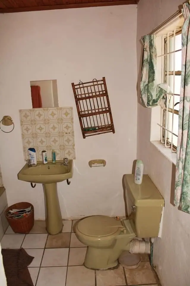 The old bathroom with dated tiles and fittings